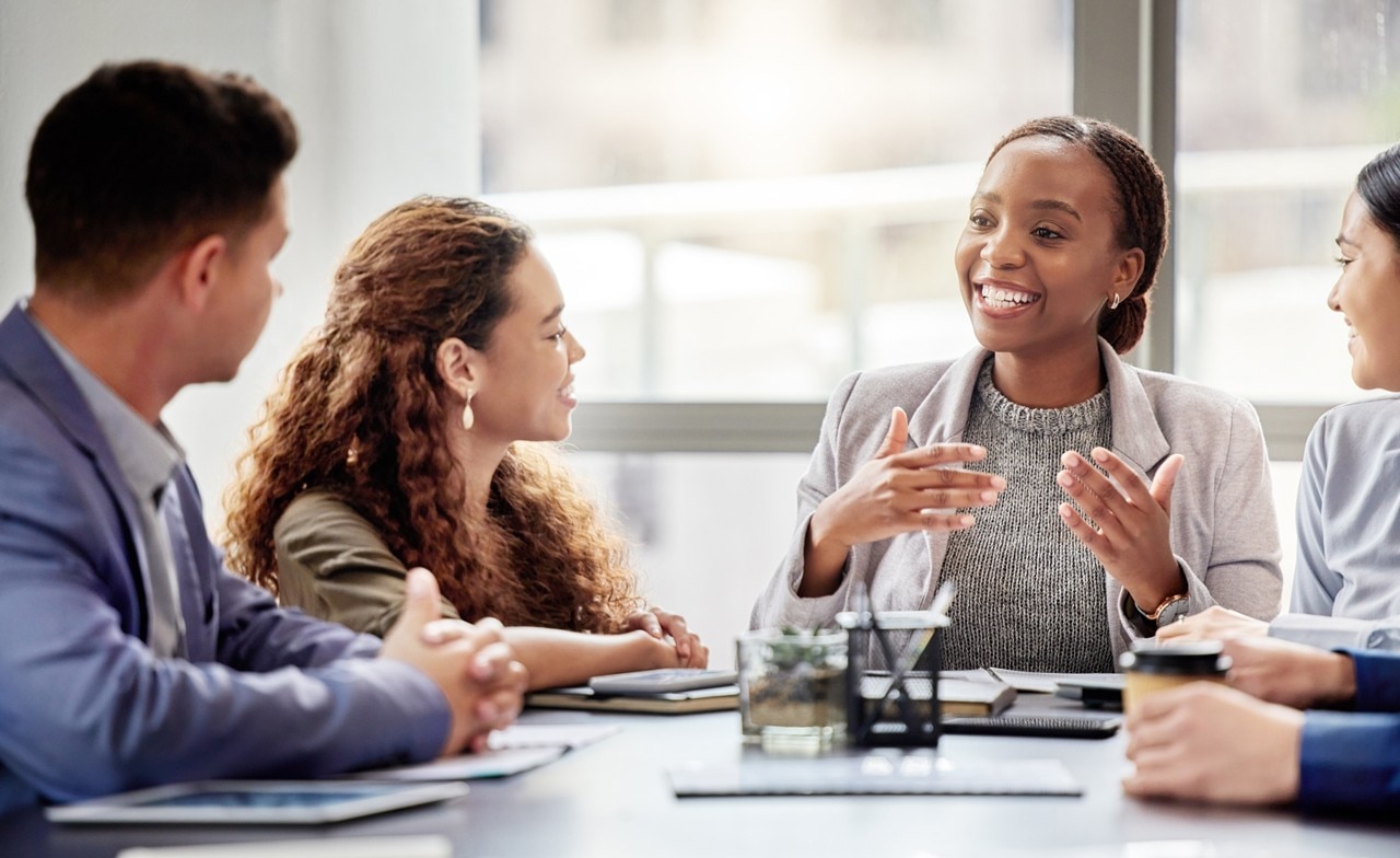 businesspeople-sitting-in-discussion Business people sitting at a table having a discussion