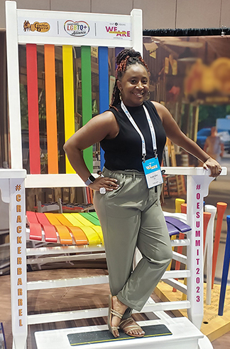 a photo of a member Krystal McCray-Brown standing on a large chair