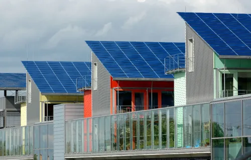 Modern homes with solar panel rooftops in a sustainable housing development