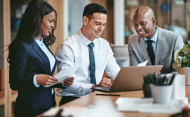 Diverse group of smiling businesspeople working in an office Diverse group of smiling businesspeople working in an office