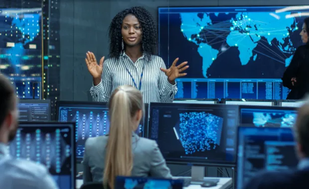 Woman Holds Briefing for a Team of Scientists that are Building Machine Learning System Woman Holds Briefing for a Team of Scientists that are Building Machine Learning System