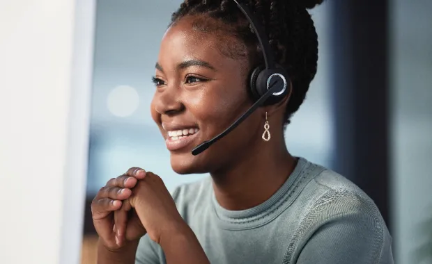 Person in a contact center speaking to a client through a headset