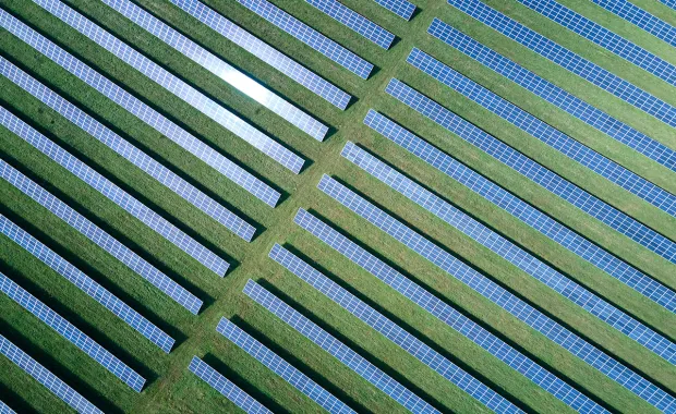 aerial view of a solar farm in a green field