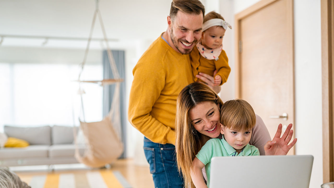 Family gathering around laptop