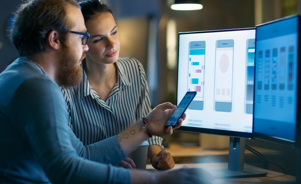 Mobile app designers working on a computer Mobile app designers working on a computer
