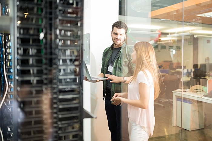 Colleagues discussing in server room