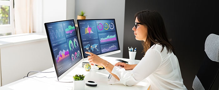 A woman looking at a computer screen of data