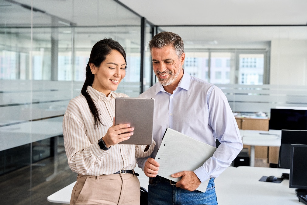 Two people working together looking at screen