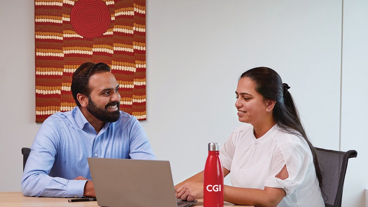 CGI Partners talk in a meeting room CGI Professionals talk in a meeting room