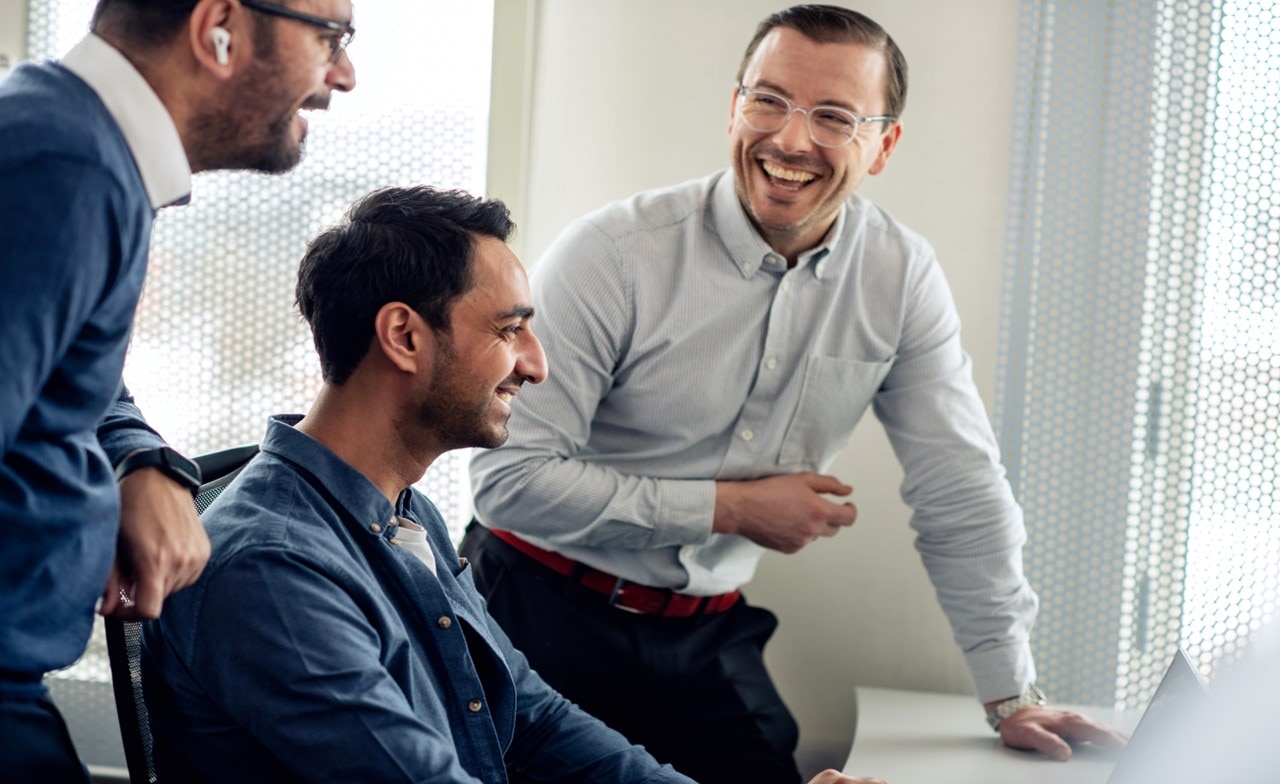 consultants discussing business over a laptop