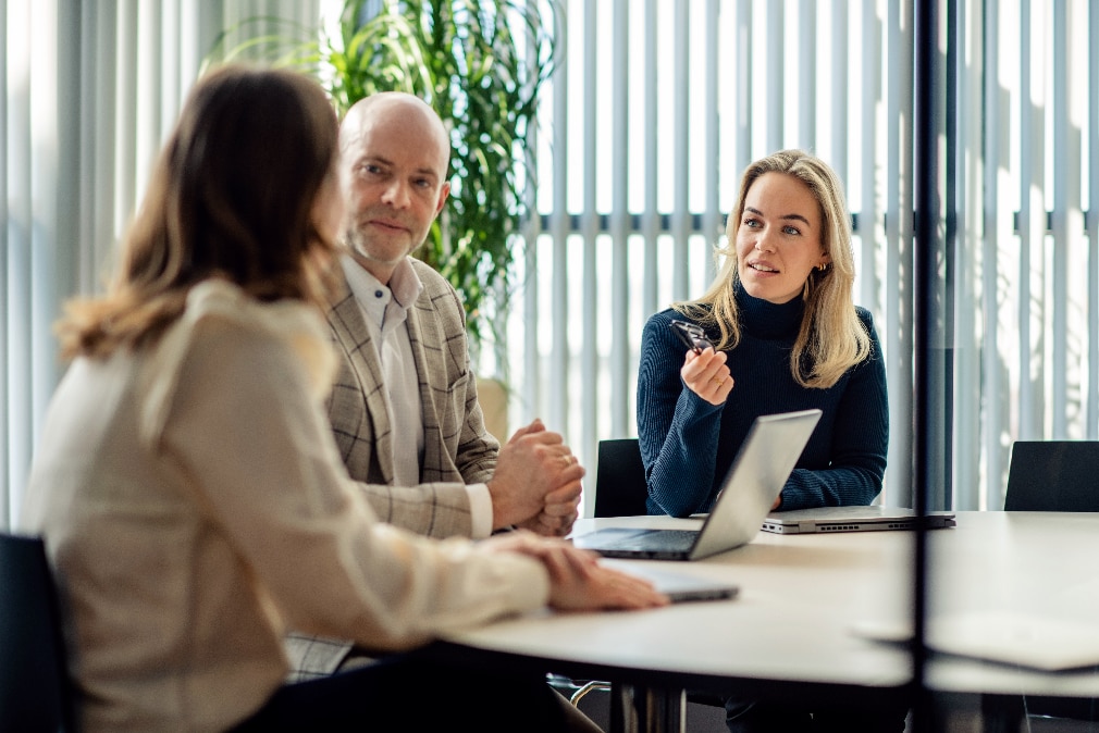 Cyber security consultant talks to clients at desk