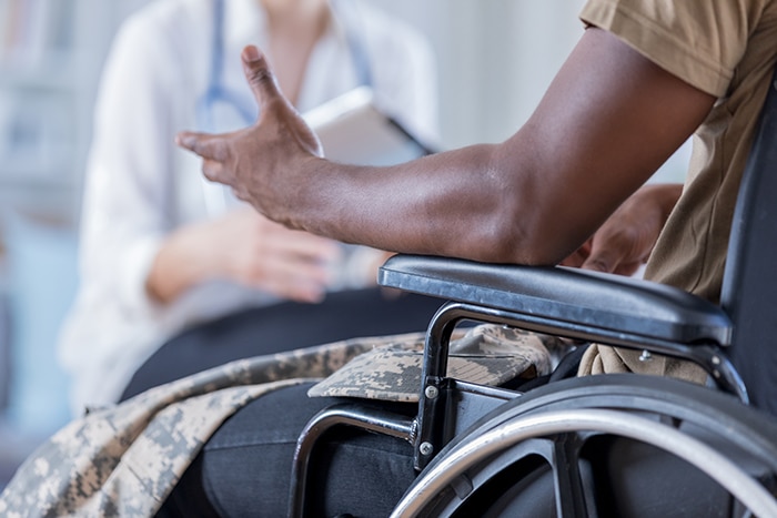 a man in a wheelchair talking to a medical professional