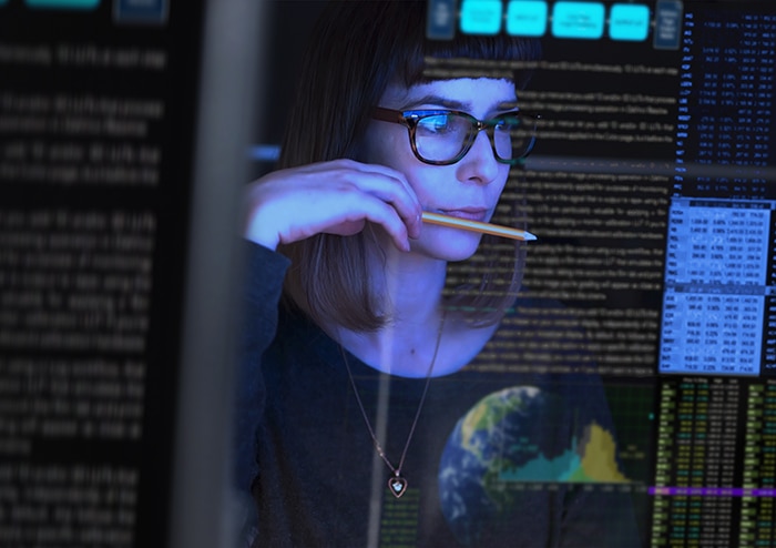 a woman looking at a computer screen with code 