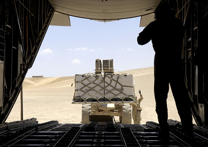 military cargo being loaded into a military airplane