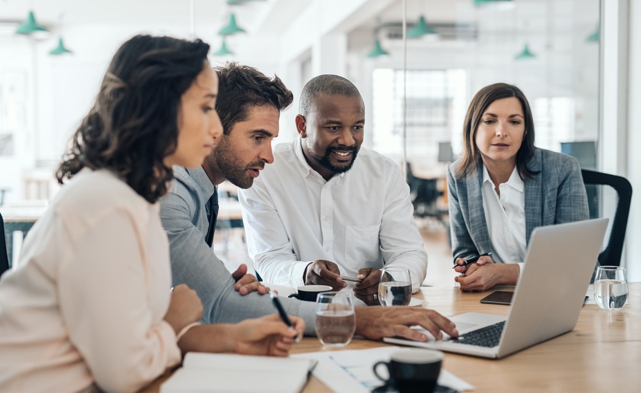 Group of professionals reviewing information on a computer