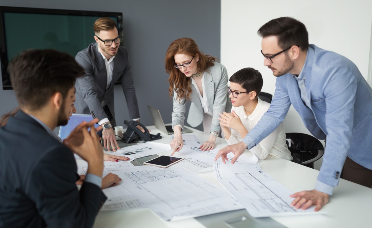 A group of people working around a conference table