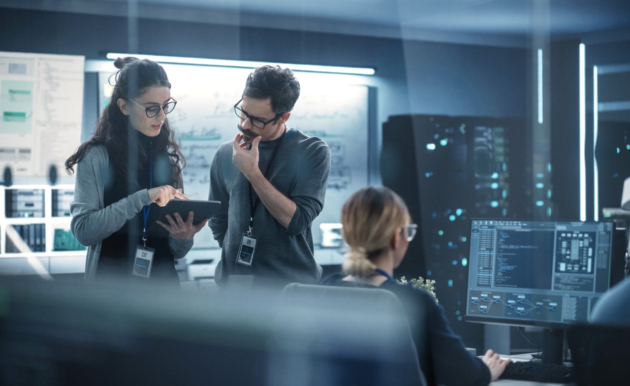 A group of colleagues working in a computer room