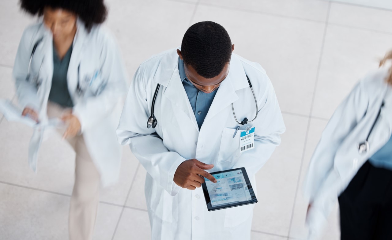 Healthcare professional reviewing brain imaging data on a tablet