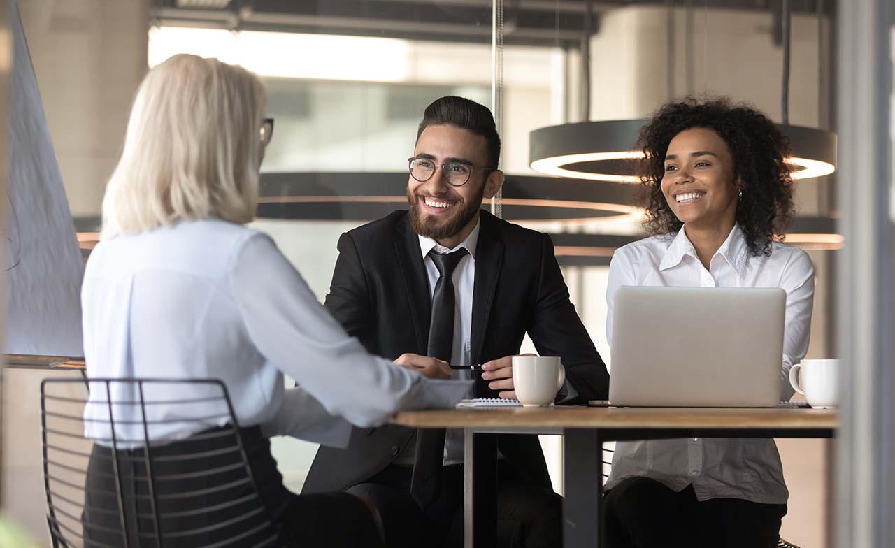 Three business consultants meeting at a table