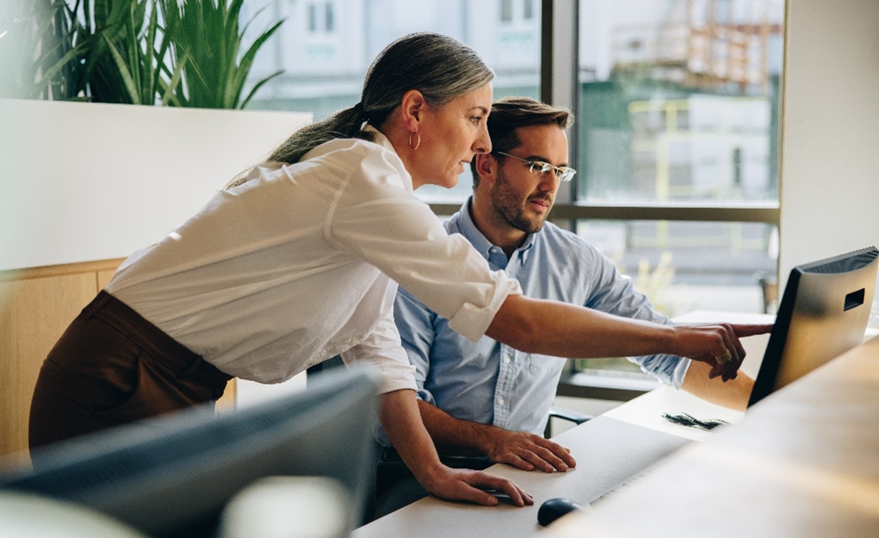 Insurance consultant pointing at computer screen Insurance consultant pointing at computer screen