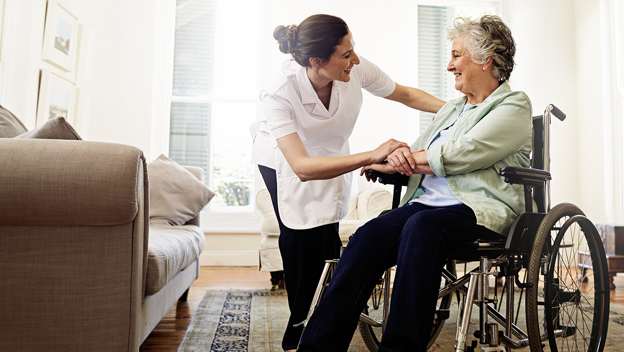 Female health care worker helping elderly patient