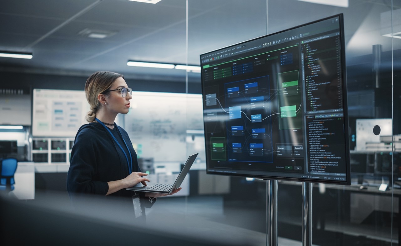 A person looking at data on a computer monitor