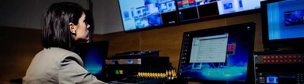 Person in tv studio adjusting the media screens Person in tv studio adjusting the media screens