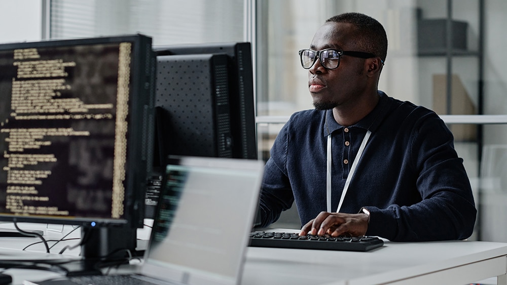 Business professional working on several computers