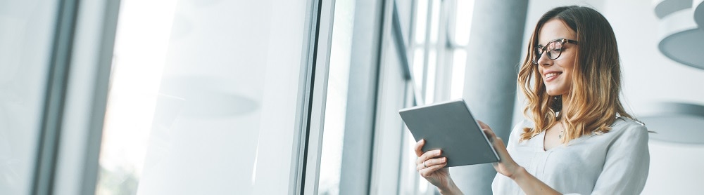 A professional standing and using a tablet