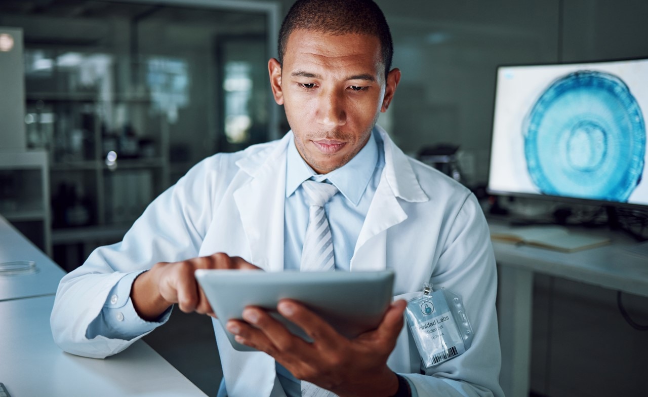 scientist researching in laboratory with tablet