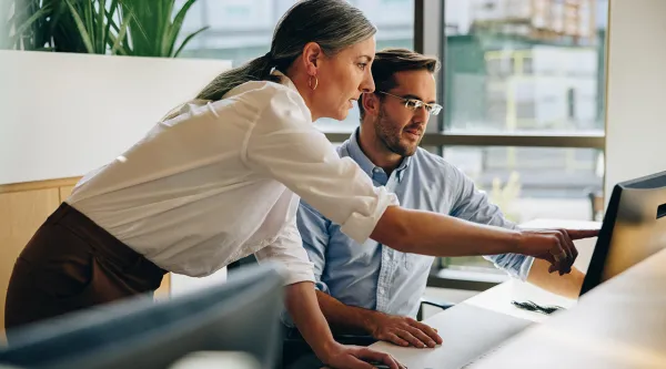 Cybersecurity consultants reviewing data on a computer