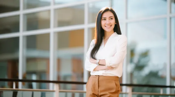 Professional standing outside of a glass office building