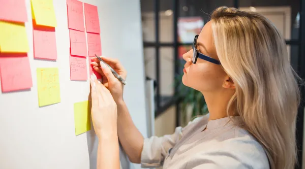 Female professional working on Agile Kanban board