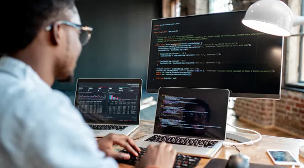 person coding on a computer