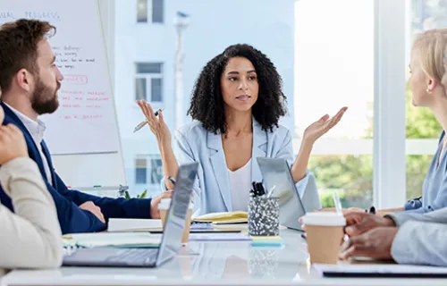 A group of diverse professionals sitting around a table having a meeting