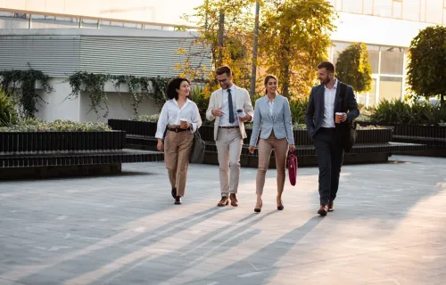 A group of people walking outside an office building