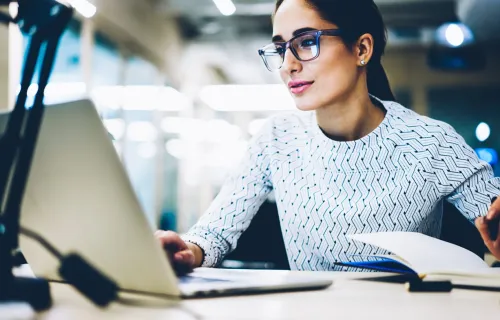 Business woman reading laptop