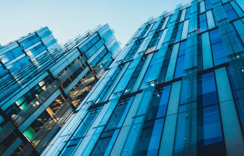 Upward-looking view of modern glass office building