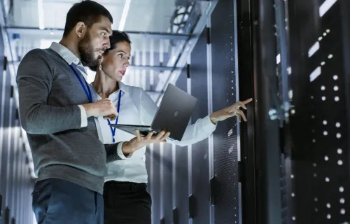 two professionals in a server room