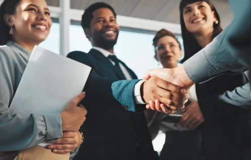 colleagues smiling, shaking hands