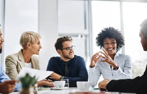 A group of consultants discussing business at a conference table