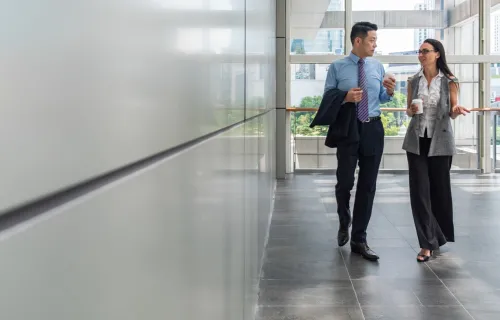 Consultants walking and talking in a hallway