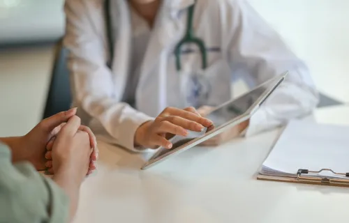 Doctor showing patient data on a tablet
