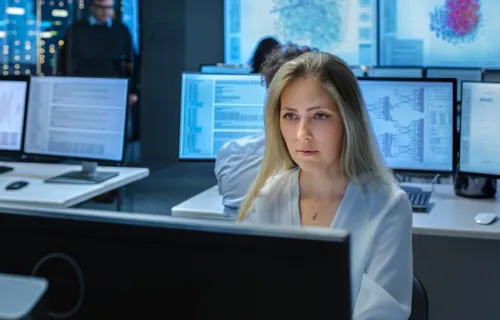 Female insurance engineer working on an AI project in a computer lab