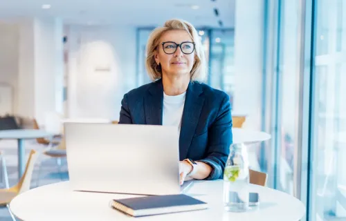 Female professional working on laptop in open space office