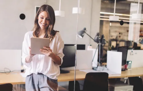 woman uses tablet in office