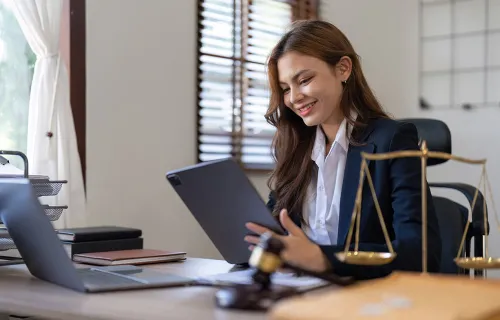 consultant on a laptop examining legal documents