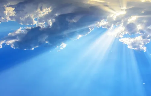 Sunrays through clouds - blue sky