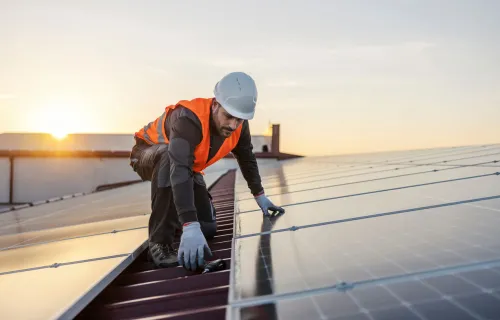 Solar panels engineer on roof fitting solar panels