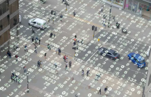 High angle shot of a London street overlaid with matrix style changing numbers.